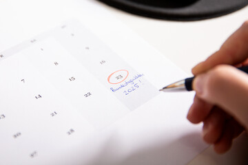 Close up of a female hand marking the 23rd of February a election voting day on a German calendar...
