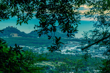 Fototapeta premium Panoramic nature background of the landscape with views of mountains, sea, trees and fishermen's houses. The beauty of the forest during the seasonal tourism season.