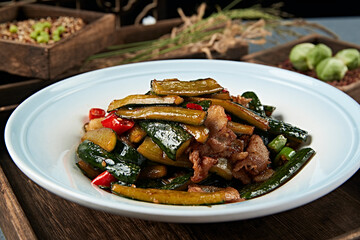 Stir-fried pork belly with garlic, rice pepper and cucumber strips
