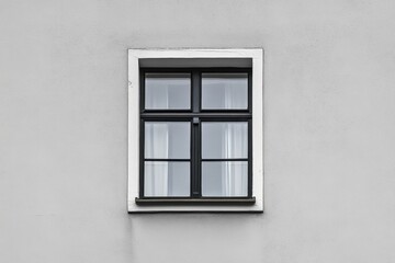 Black framed window with four panes on a gray wall
