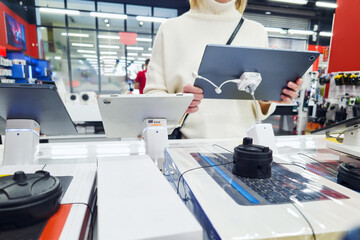 Woman customer with digital tablet in store