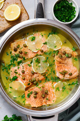 Trout picatta with capers and lemon in a frying pan..style hugge.