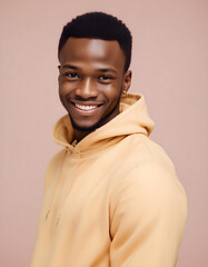 Stylish Nigerian man with a joyful expression, dressed in trendy clothes, smiling at the camera