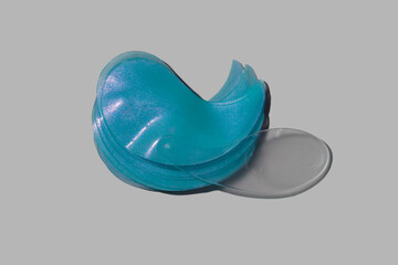 Cosmetic swatch blue eye patches with clear plastic stick applicator with right way to take product...