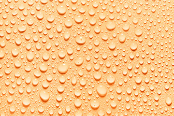 Cosmetic moisturizing liquid drops on orange background. Toner or lotion. Hyaluronic serum