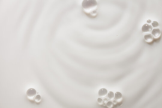 Cosmetic cream milk foam texture milky beige colored background