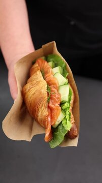 Croissant with salmon, cheese and greens.