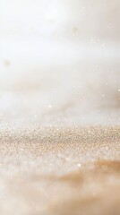 A close-up of a light beige glitter background with bokeh, gold shimmer, and a thin line at the bottom