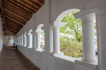 The corridor in the temple is located in Sri Lanka.