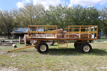 Old farm trailer with hay bricks