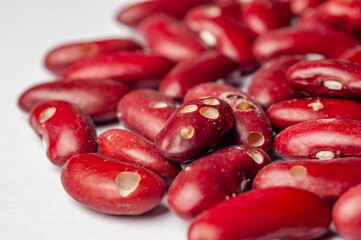 A close-up captures the rich texture and deep red color of a heap of kidney beans.
