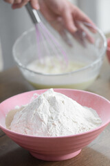 the girl whips the ingredients in a bowl