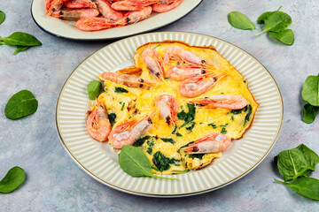 Omelet with shrimp and spinach.