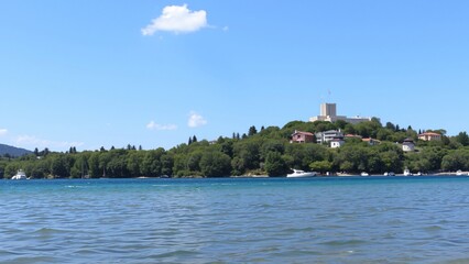 Panoramic View of Coastal Town with Castle and Calm Sea on a Sunny Day