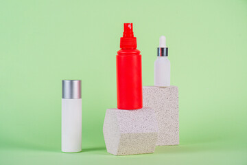 White tube and red spray on light white podiums. White blank unbranded flacons with cosmetology...