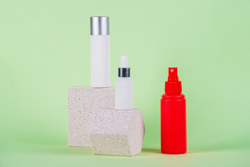 White tube and red spray on light white podiums. White blank unbranded flacons with cosmetology...