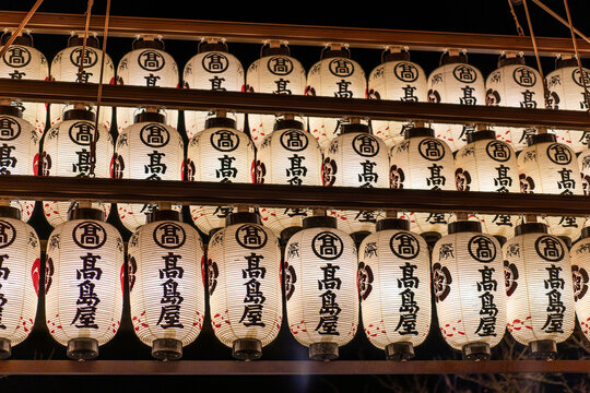 A row of white Japanese lanterns at night. Yasaka Shrine in Kyoto, Japan 