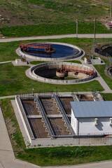 Overview of a modern water treatment facility showcasing circular tanks and filtration systems amid...