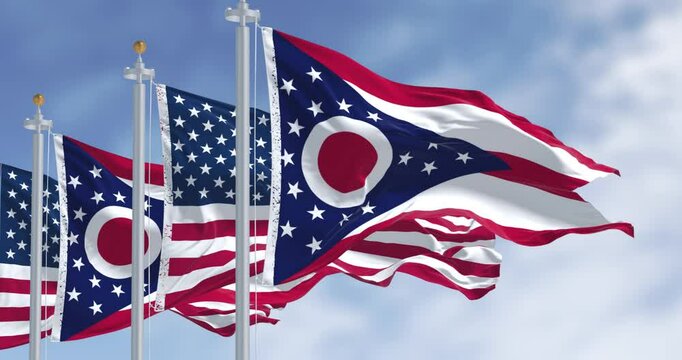 Ohio and national US flags waving in the wind on a clear day
