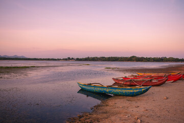 A canoe under the sunset, located in Sri Lanka.