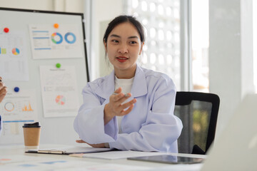 Physician discussing healthcare strategies with colleagues in a professional setting.