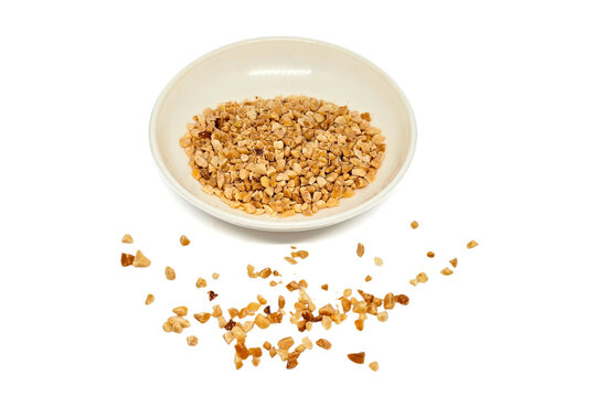 Crumbled Peanuts in a white bowl and scattered on isolated white background. Crushed Roasted Nuts, Heap of Chopped Nut Crumbs. Ground, milled, crushed or granulated peanut pile isolated.