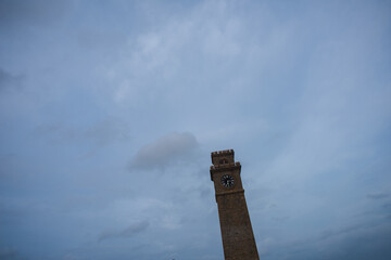 The ancient clock tower is located in Sri Lanka against a blue sky background.