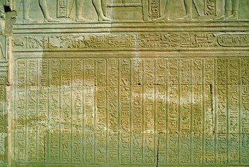 Ancient Egyptian hieroglyphs carved on stone  in the Luxor temple , Egypt . A formal writing system...