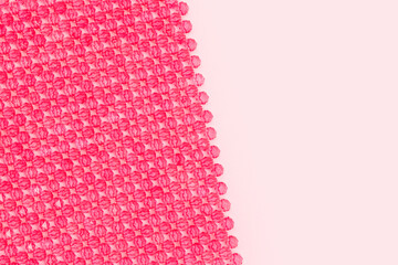 Detail for handcraft bag made from acrylic beads on a pink background. Place for text.