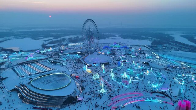 Slow aerial shot of the Harbin Ice Festival at Blue Hour in Harbin, China.