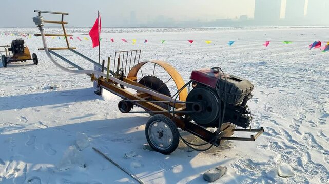 Handheld shot of an ice-cutting machine on the frozen Songhua River in Harbin, creating parallel cuts in the ice. China