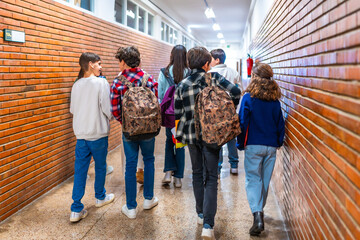Group of students walking in school hallway between classes