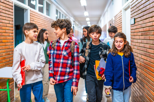 Group of elementary school students walking in school hallway