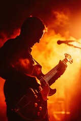 Obraz premium Musician plays guitar on stage with smoke and dramatic lighting; for entertainment