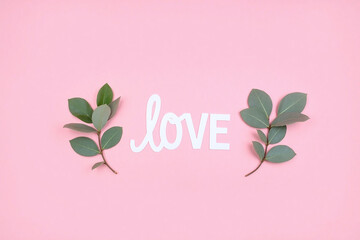 Pink bg LOVE in cursive white capital letters with eucalyptus leaves