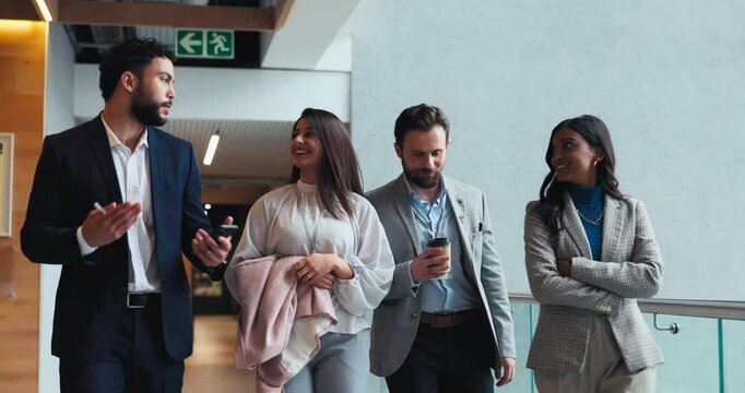 Teamwork, walking and discussion with business people at conference for networking, support and diversity. Seminar, convention center and tradeshow with group of employees in lobby for solidarity