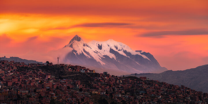 Illimani snow mountain under the sunset burned clouds