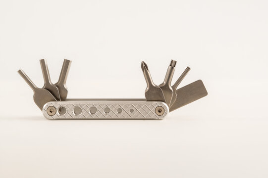 handy pocket stainless steel multi tool with drivers hex, torx allen keys isolated on a white background