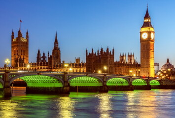 Big Ben tower of Houses of Parliament and Westminster bridge at night, London, UK