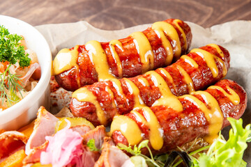 A close-up of flavorful grilled sausages drizzled with mustard, served alongside a fresh side salad. Perfect for a hearty meal or barbecue setting, showcasing deliciousness and culinary delight.