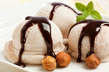 Hazelnut ice cream scoops with chocolate topping