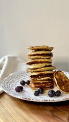 stack of banana pancakes with honey and berries 