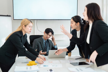 Diverse business team engaged in a heated discussion during a strategy meeting, showcasing collaboration and conflict resolution.