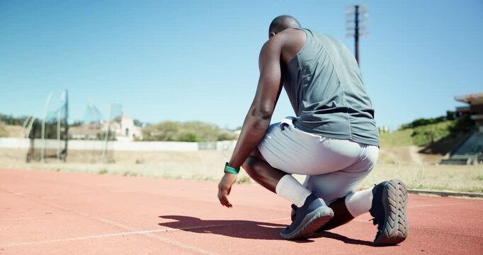 Back, man and ready to start on track for race challenge, pace workout or endurance training at sport stadium. Begin, set and runner at sports arena for marathon fitness, running practice or exercise