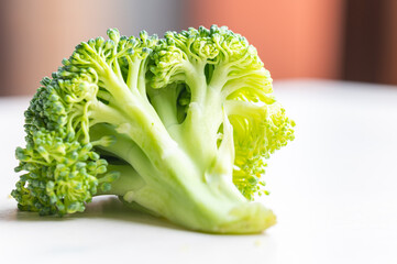 Broccoli, placed on white surface. Nutritional qualities and recipes.