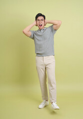 Young Asian business man on green background