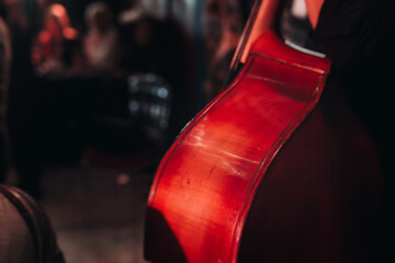 Concert view of violoncello player with vocalist and musical orchestra band, during jazz concert,...