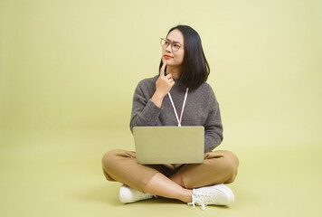 Young Asian businesswoman on green background
