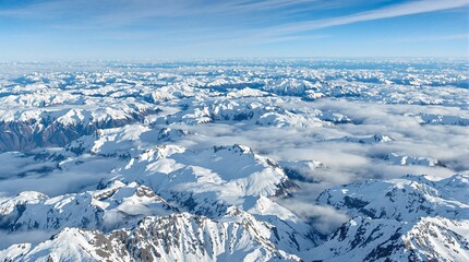 Fototapeta premium Aerial view of snowy mountains, tranquil mood, vast landscape under blue sky