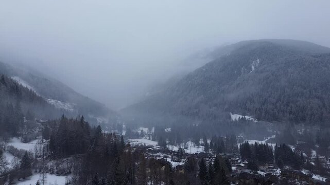 This is a large ski area that prepares Cortina 2026 in Italy. The locations are captured with a drone that shows the beauty of winter sports that combine blue sky, white snow and a cloudy day